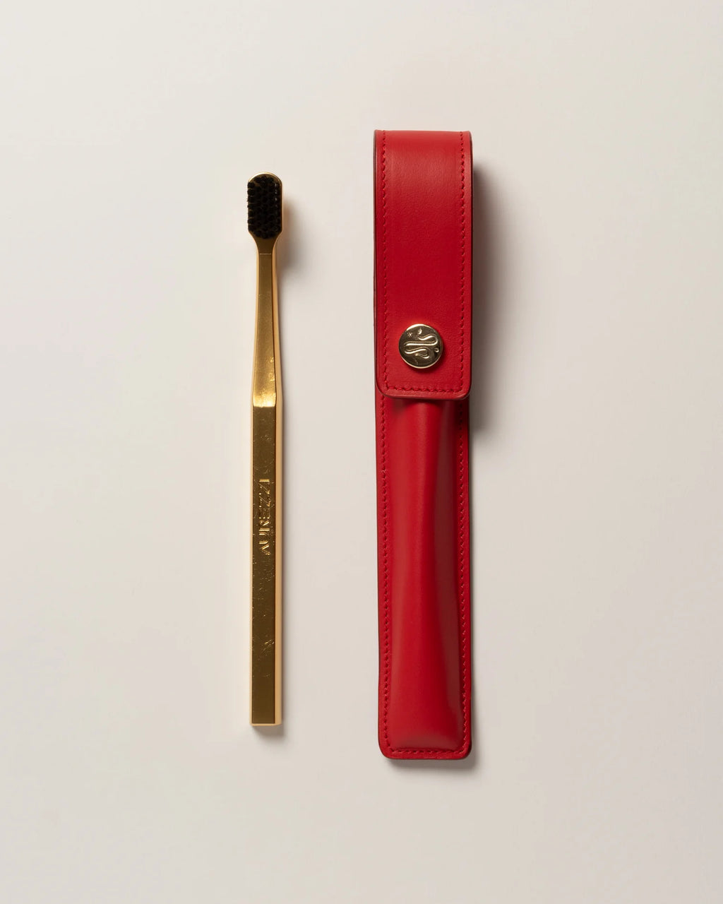 RED LEATHER CASE BUTTON & TOOTHBRUSH
