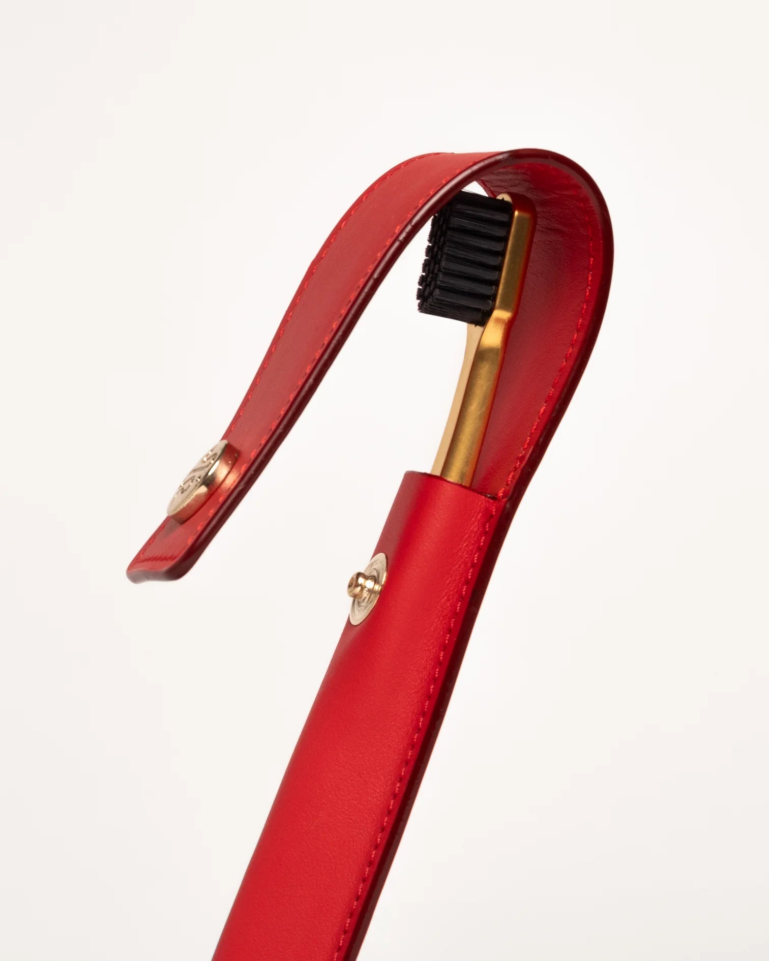 RED LEATHER CASE BUTTON & TOOTHBRUSH