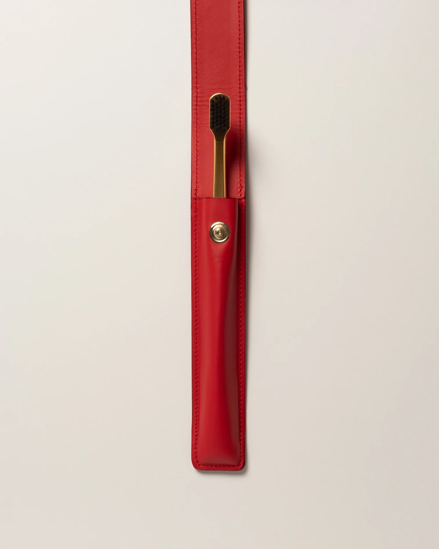 RED LEATHER CASE BUTTON & TOOTHBRUSH